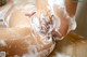 A woman is taking a bath with foam on her body.